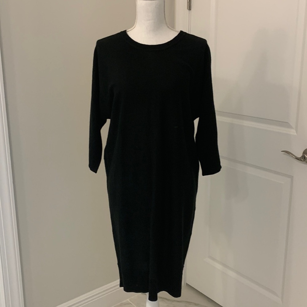 Black sweater dress with rose colored zipper going up the back